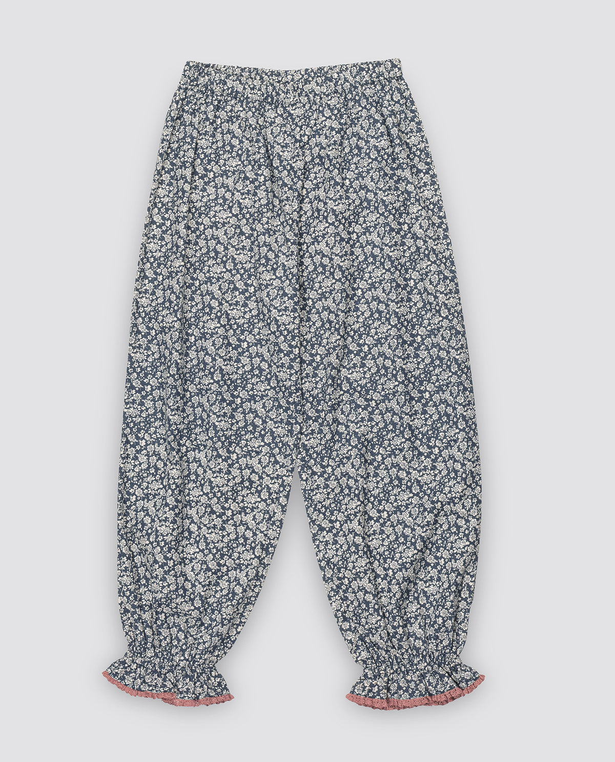 Navy and white floral trousers with elasticated waist and contrasting pink trim, made from organic materials for a sustainable children's wardrobe.