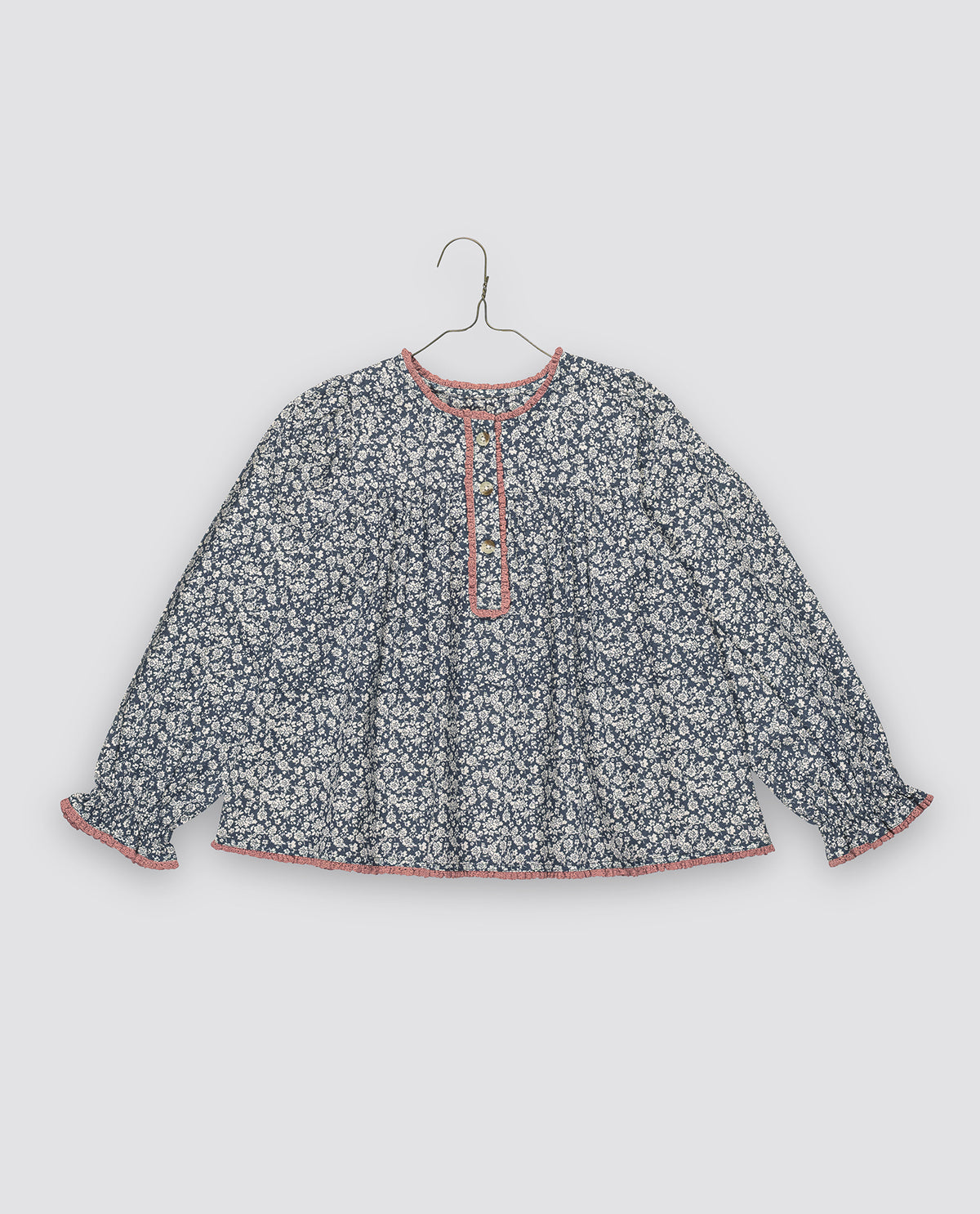 Vintage inspired long sleeve navy & white floral blouse with contrasting pink trim and frilly cuffs, made with organic cotton for a sustainable children's wardrobe.