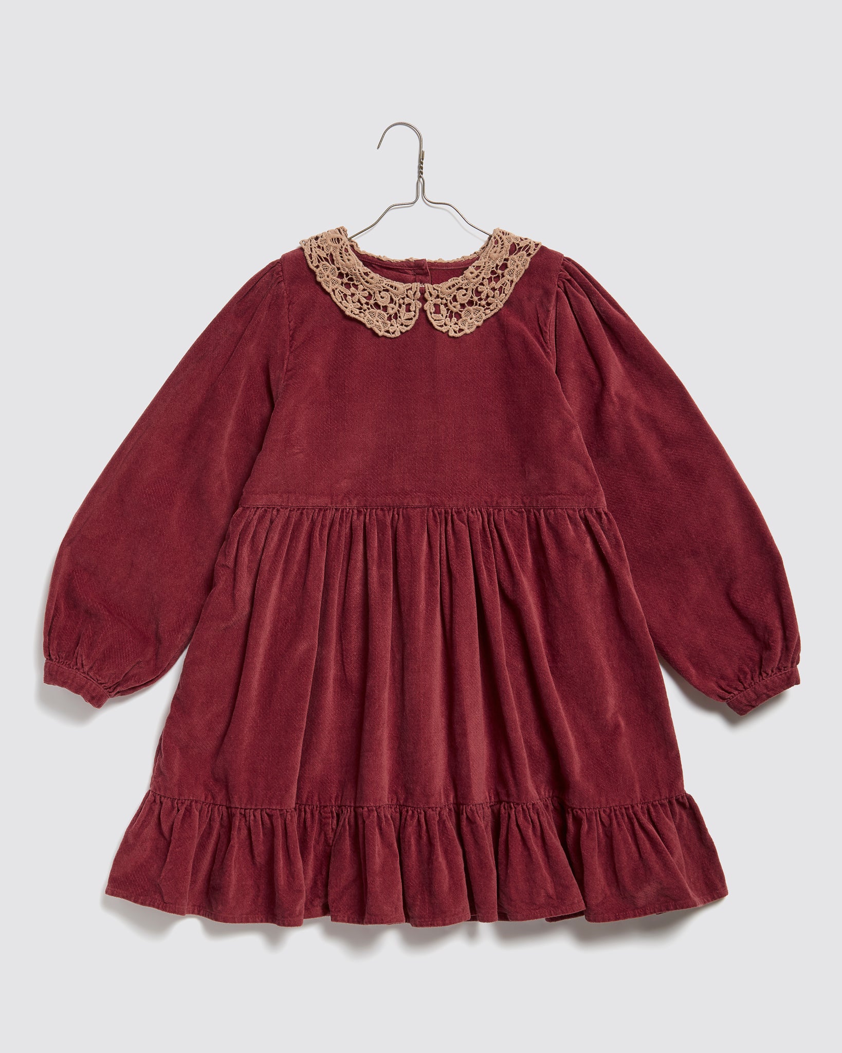 Vintage style red velvet girls dress with long puffed sleeves and a delicate crochet lace collar, made from organic cotton for sustainable, ethical kids clothing.