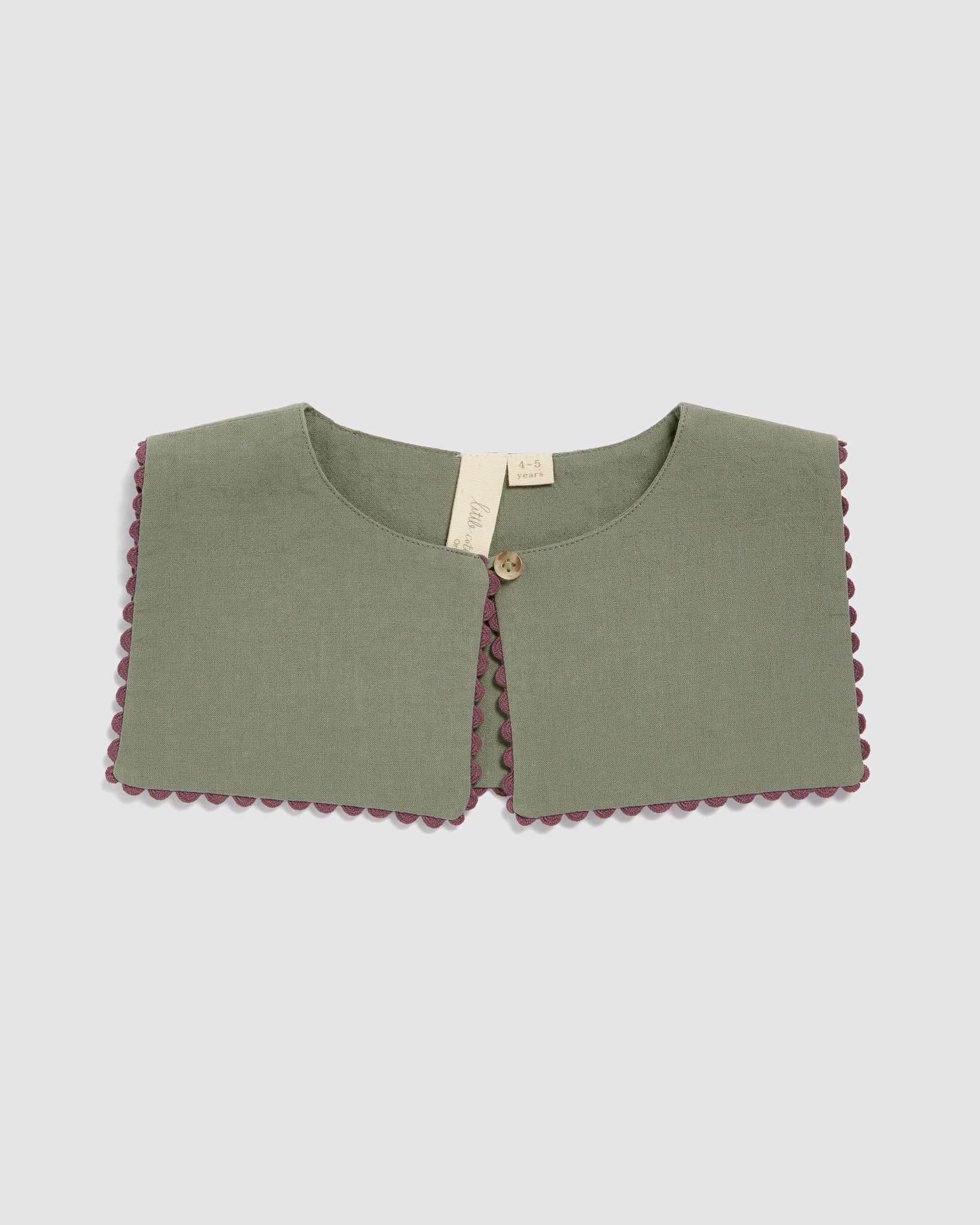 Green vintage style collar for kids made from organic cotton with decorative trim, reflecting slow, natural, and ethical children's clothing.