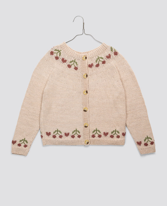 Cream hand-knitted children's cardigan with cherry pattern details in soft cotton, featuring vintage style and sustainable, ethically made design for girls.