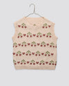 Hand-knitted children's vest in soft organic cotton with a vintage-inspired cherry pattern, showcasing natural materials and sustainable, ethical craftsmanship.
