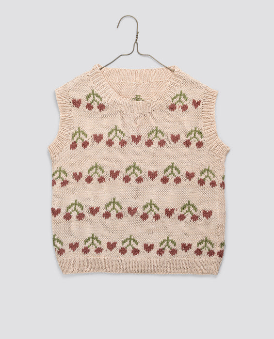 Hand-knitted children's vest in soft organic cotton with a vintage-inspired cherry pattern, showcasing natural materials and sustainable, ethical craftsmanship.