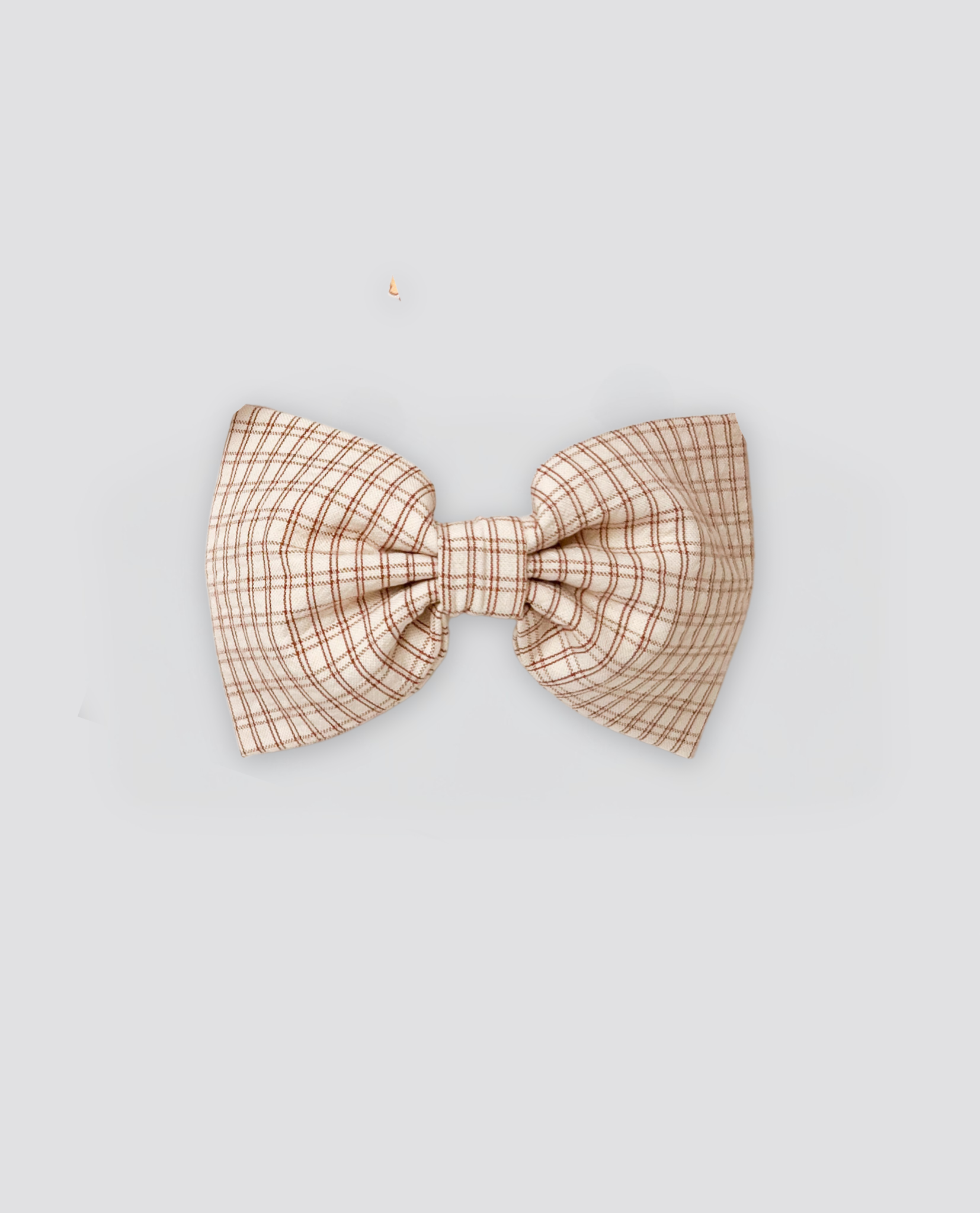 Beige and brown checked bow hair clip made from natural materials, designed in a vintage style for children with a focus on organic, ethical, and sustainable fashion.