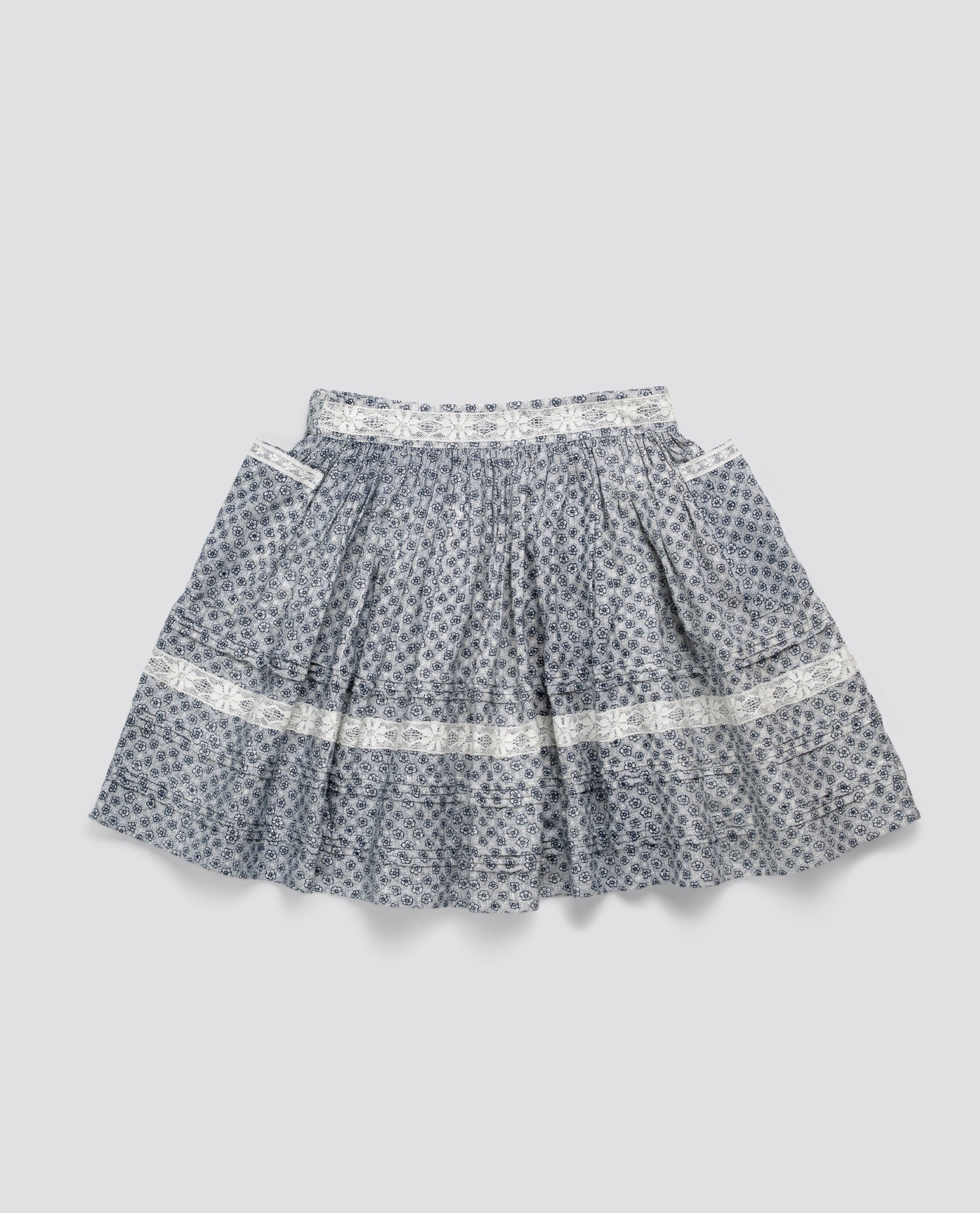 Blue floral organic cotton skirt for kids with vintage style and delicate white lace trim, ethically made for sustainable children's clothing.
