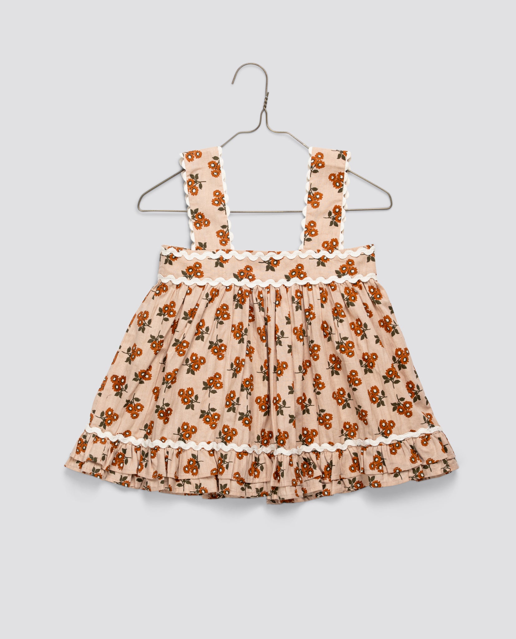 Vintage style girls sun top in organic cotton with marigold floral pattern, featuring wide straps and delicate ruffled edging, ethically made and sustainable.