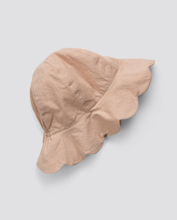 Soft pink scalloped organic cotton hat for children, featuring a vintage-inspired design that is ethically made and sustainably crafted with natural materials.