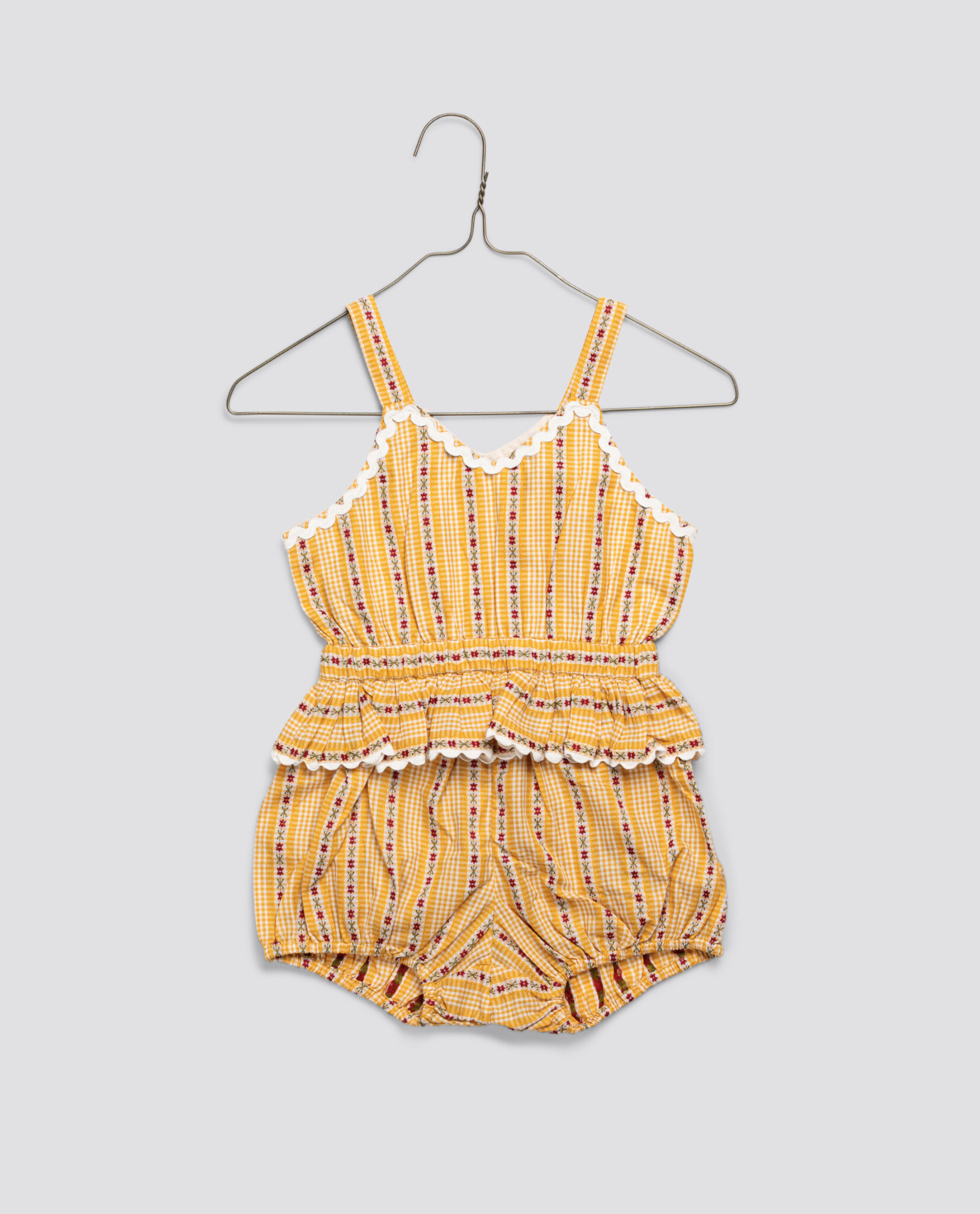 Yellow and orange striped vintage-style romper for girls with delicate floral accents and scalloped trim, made from organic cotton for sustainable, natural children's clothing.