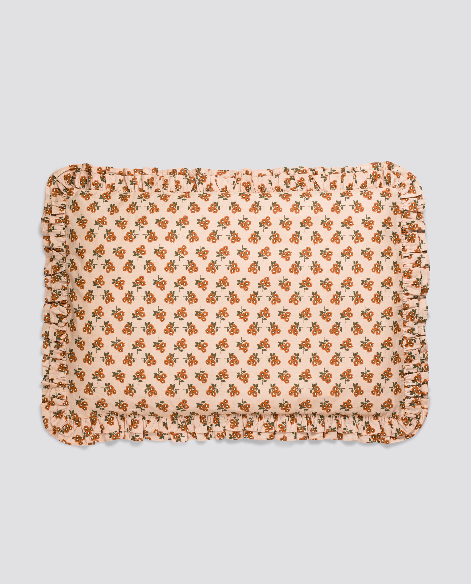 Soft cotton pillowcase with a delicate marigold floral pattern and ruffled edges, crafted with natural, organic materials for a safe and sustainable childhood.