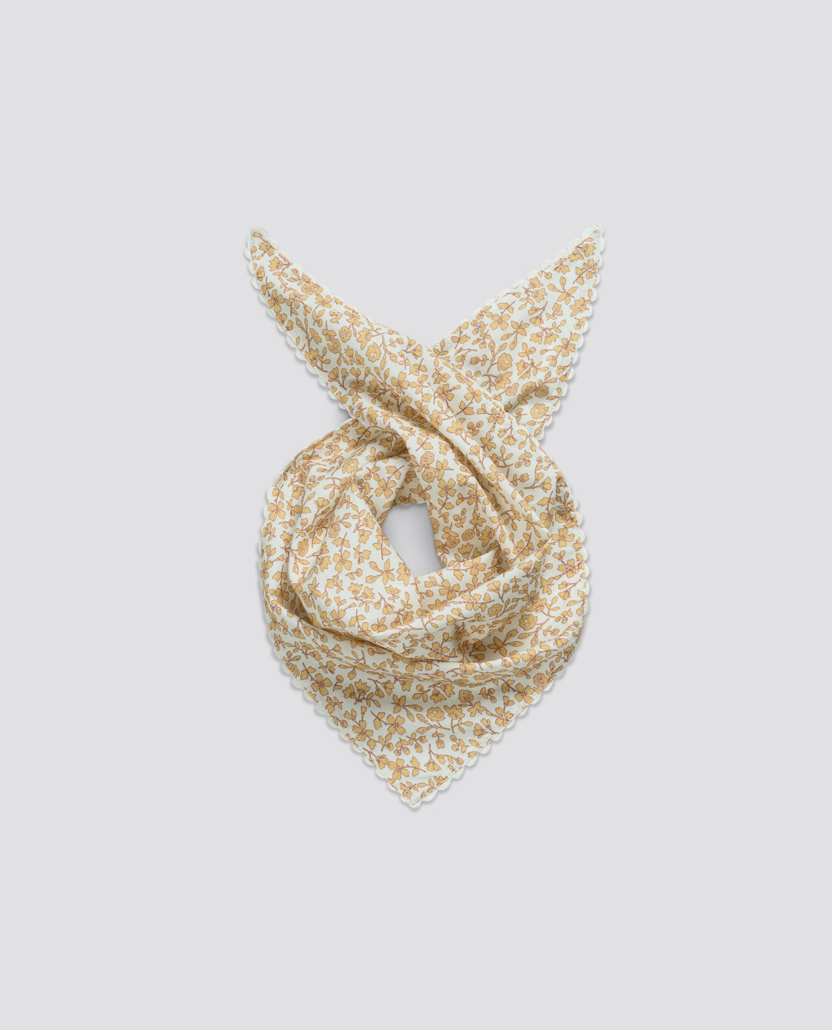 Lightweight children's scarf with delicate floral print in soft natural tones, made from organic cotton, perfect for adding vintage charm to kids' outfits.