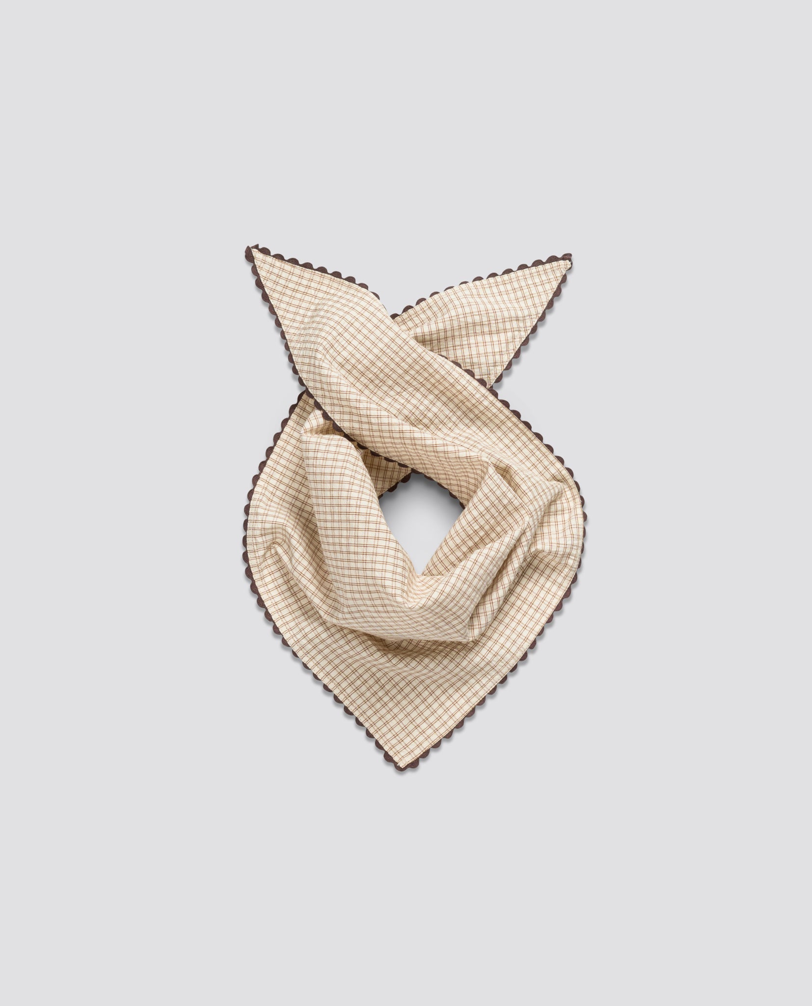 Soft beige checkered children's scarf with delicate brown trim, made from organic natural cotton, reflecting a vintage and sustainable style.