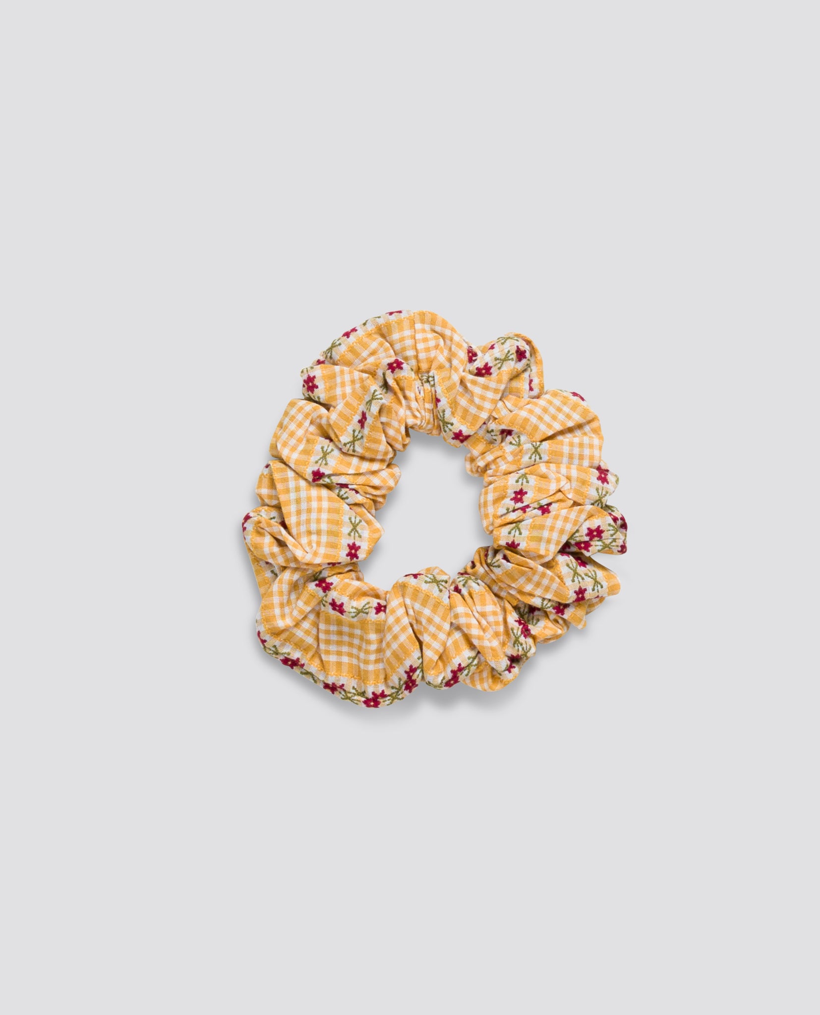 Yellow gingham patterned scrunchie with small red floral accents made from soft organic cotton, reflecting vintage-inspired sustainable children's accessories.