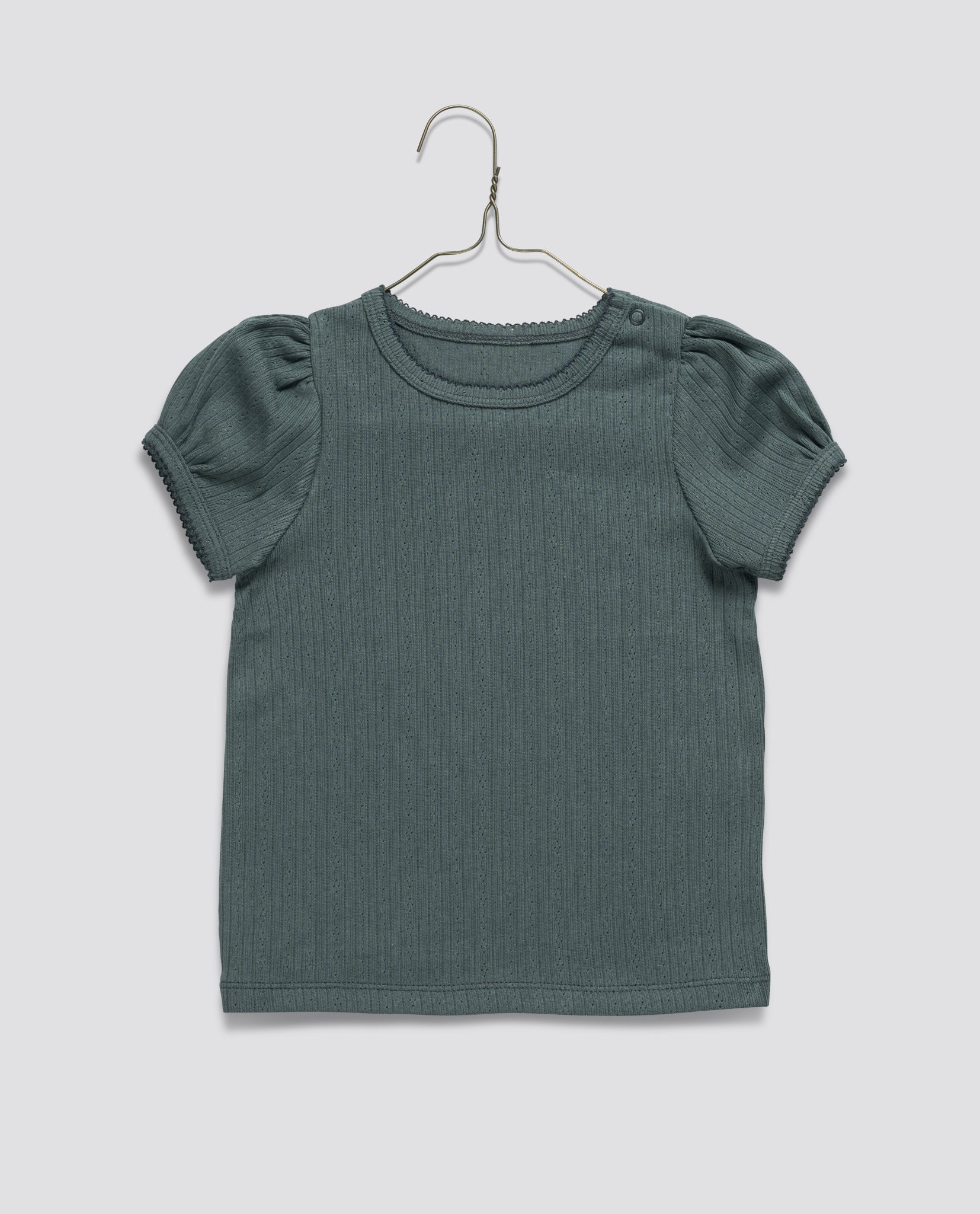 Blue organic jersey cotton children's t-shirt with subtle pointelle pattern, puffed sleeves, and vintage-inspired detailing, designed for comfort and sustainability.