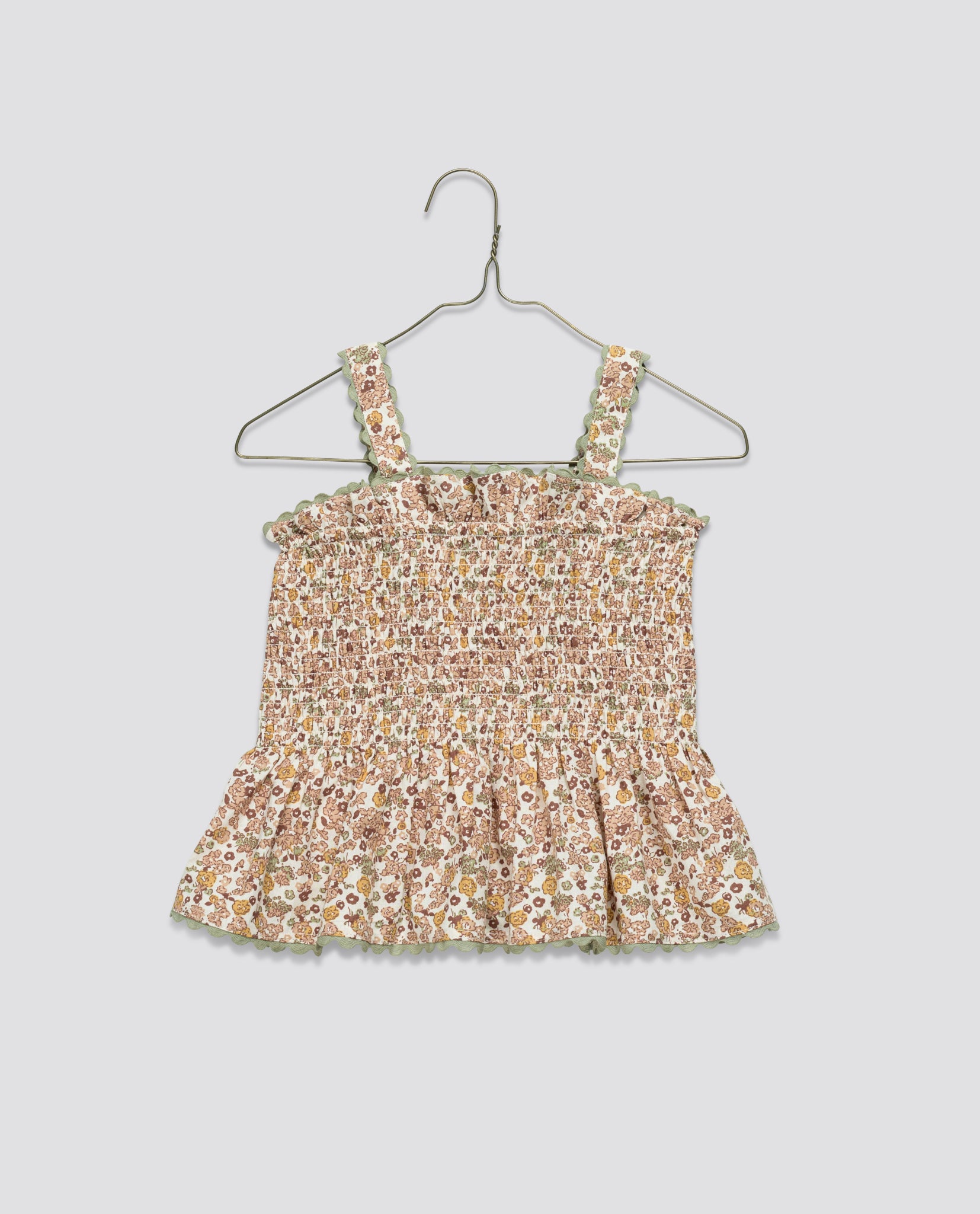 Lightweight girls top in soft organic cotton with a delicate vintage-inspired floral print, featuring smocked bodice and ruffled straps for a charming, natural style.