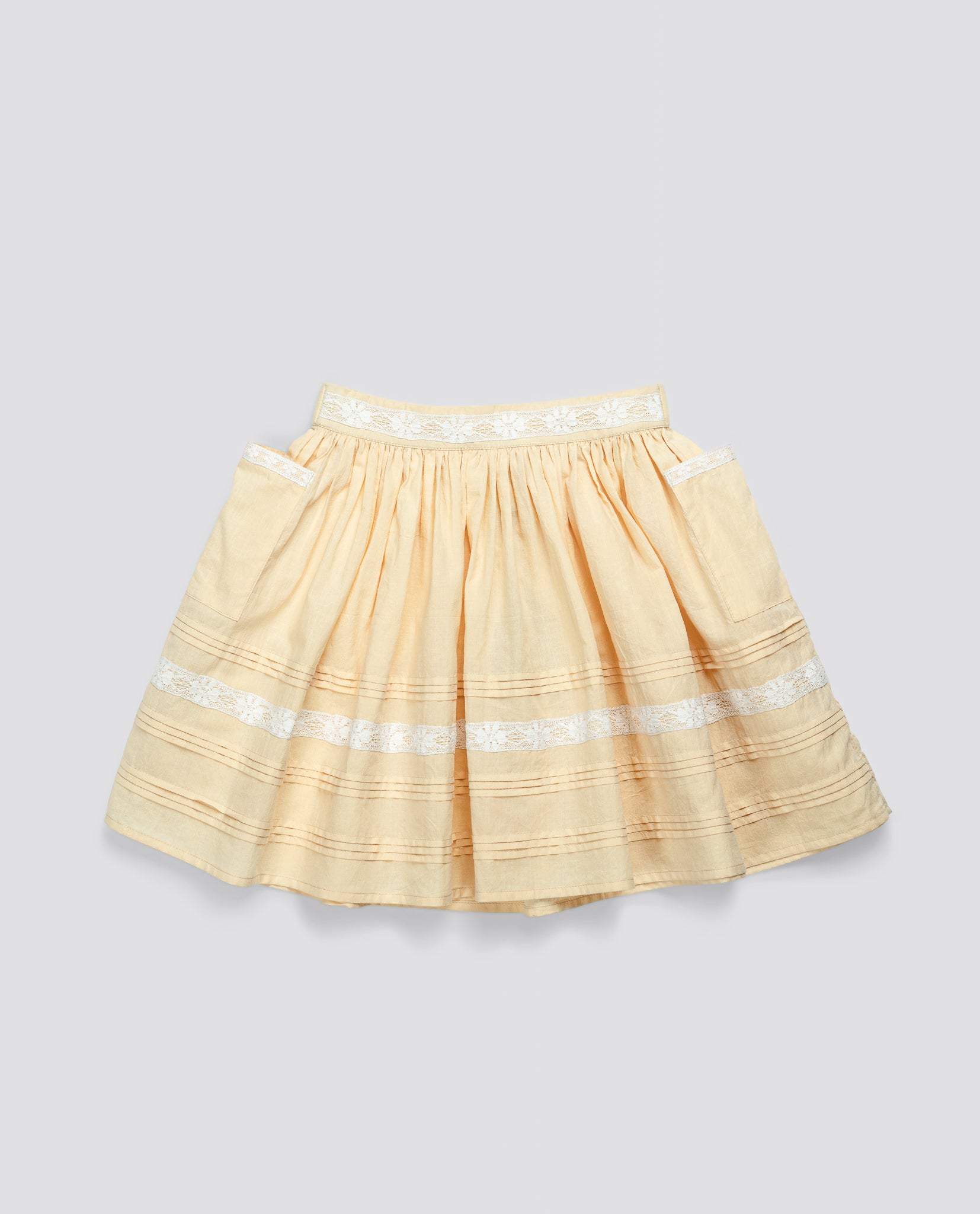 Butter yellow organic cotton skirt for kids featuring vintage-inspired white embroidered details, designed with sustainable and ethical craftsmanship in mind.