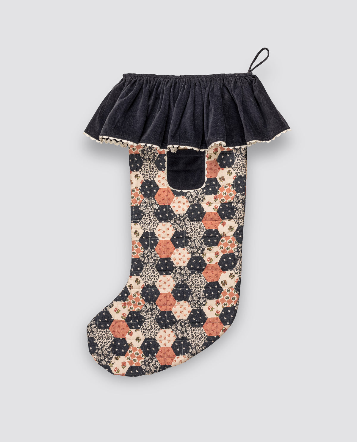 Festive patchwork floral stocking with contrasting velvet frill design, made with organic cotton for an ethically made sustainable children's decoration.
