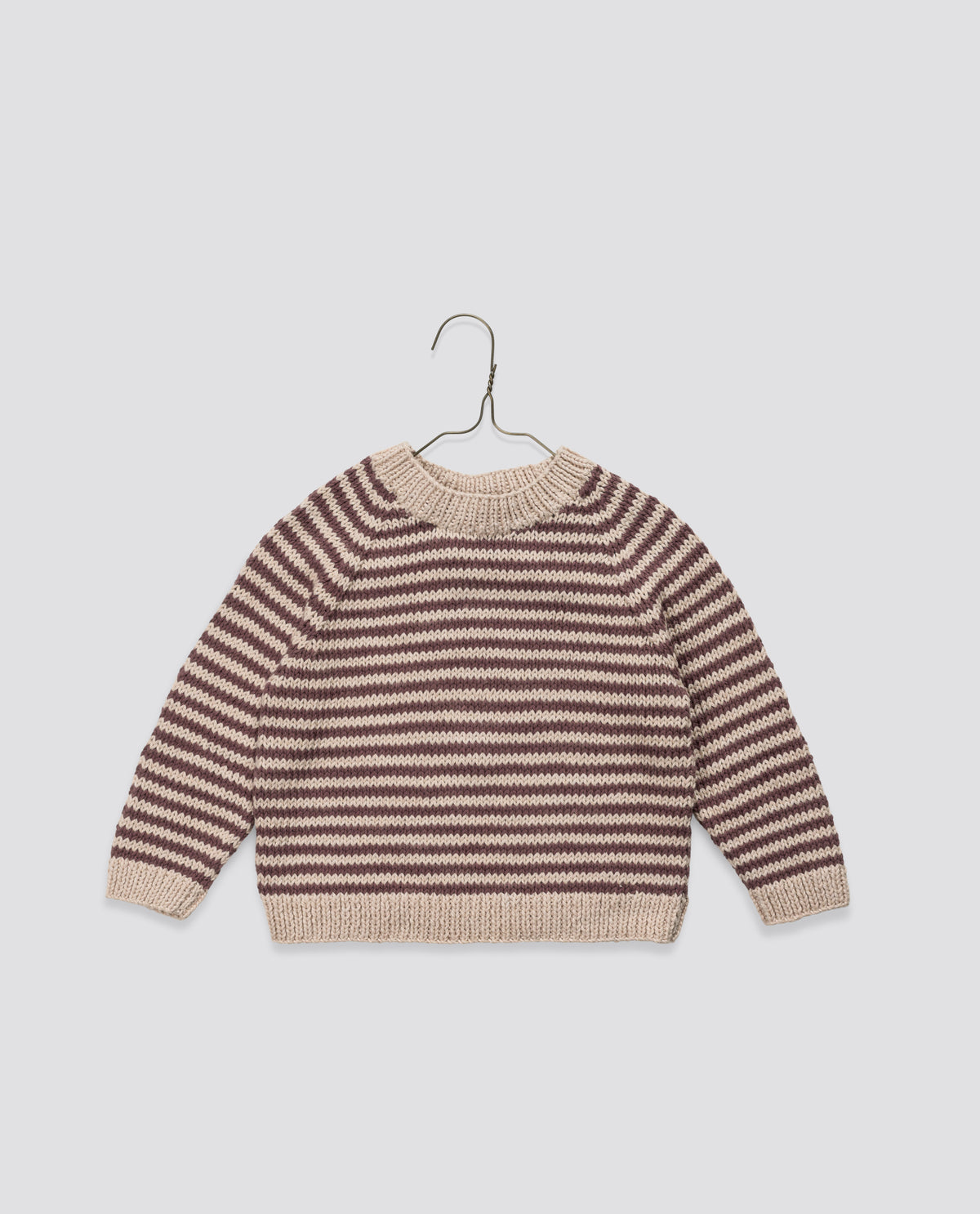 Plum and beige hand-knitted children's jumper in vintage-style ethically made with organic cotton representing an sustainable children's style.