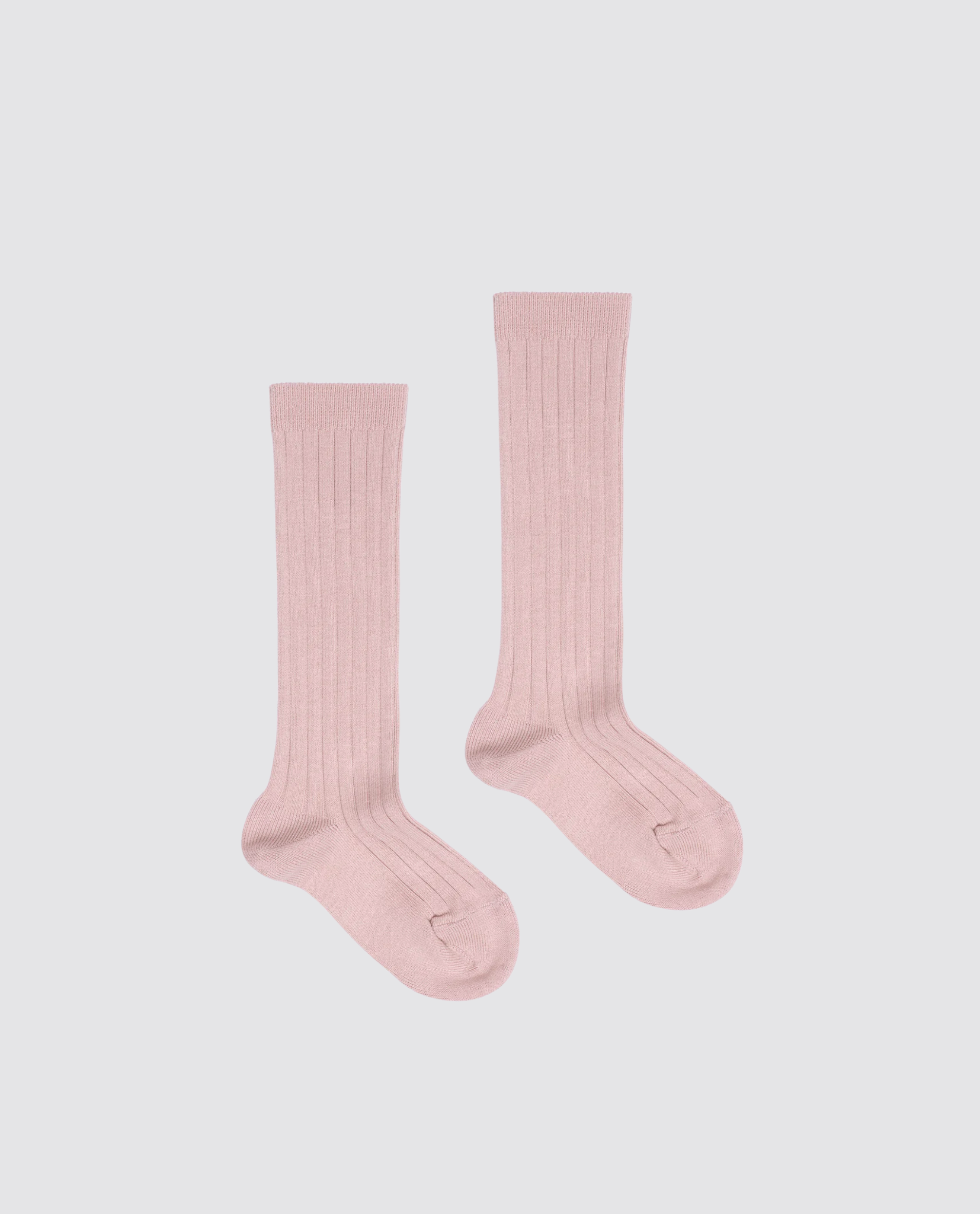 Pair of soft pink ribbed knee-high socks made from a cotton blend, designed for kids with a vintage-inspired style, emphasizing natural and sustainable children's clothing.