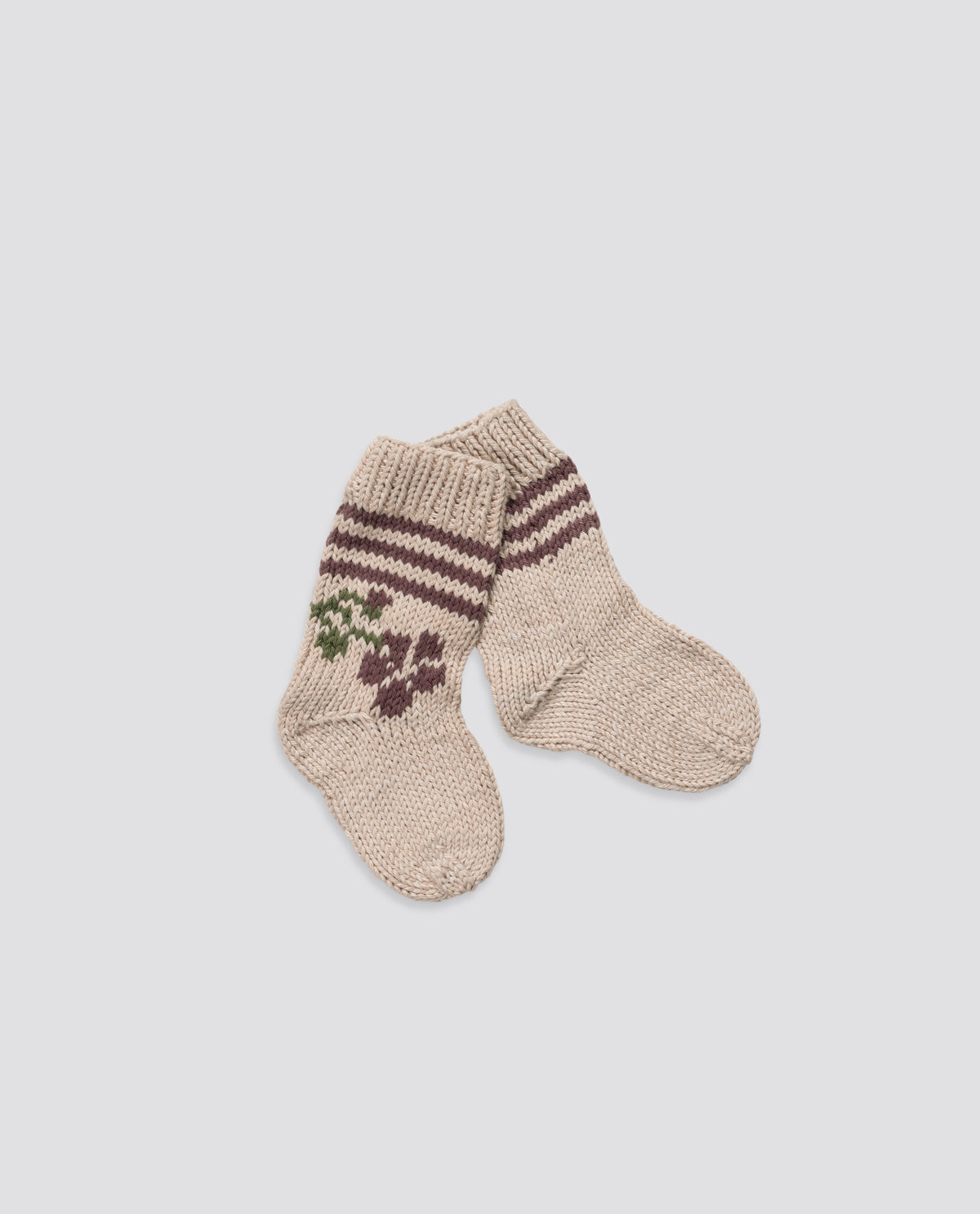 Cosy super soft hand-knitted socks with rose design, reflecting vintage style and sustainable craftsmanship. 