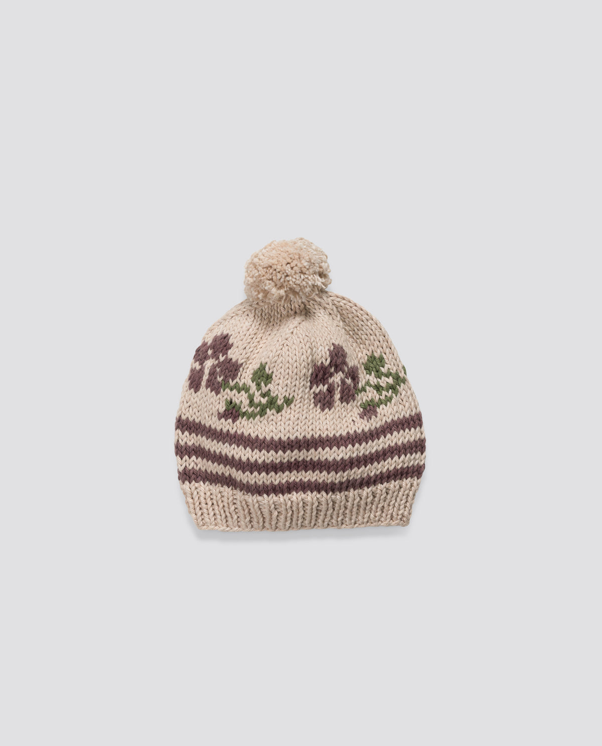 Hand-knitted bobble hat made with soft wool with vintage-inspired rose pattern, crafted with care for a sustainable children's style.