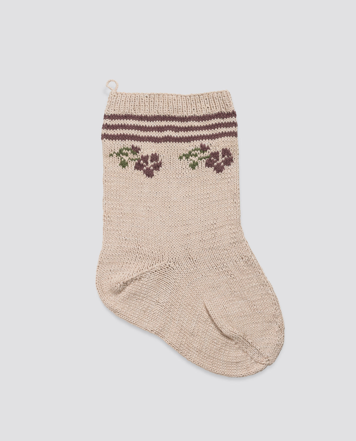 Hand-knitted stocking in natural materials featuring a vintage-inspired  rose and stripe pattern in plum and beige, designed with care for a sustainable holiday decoration.