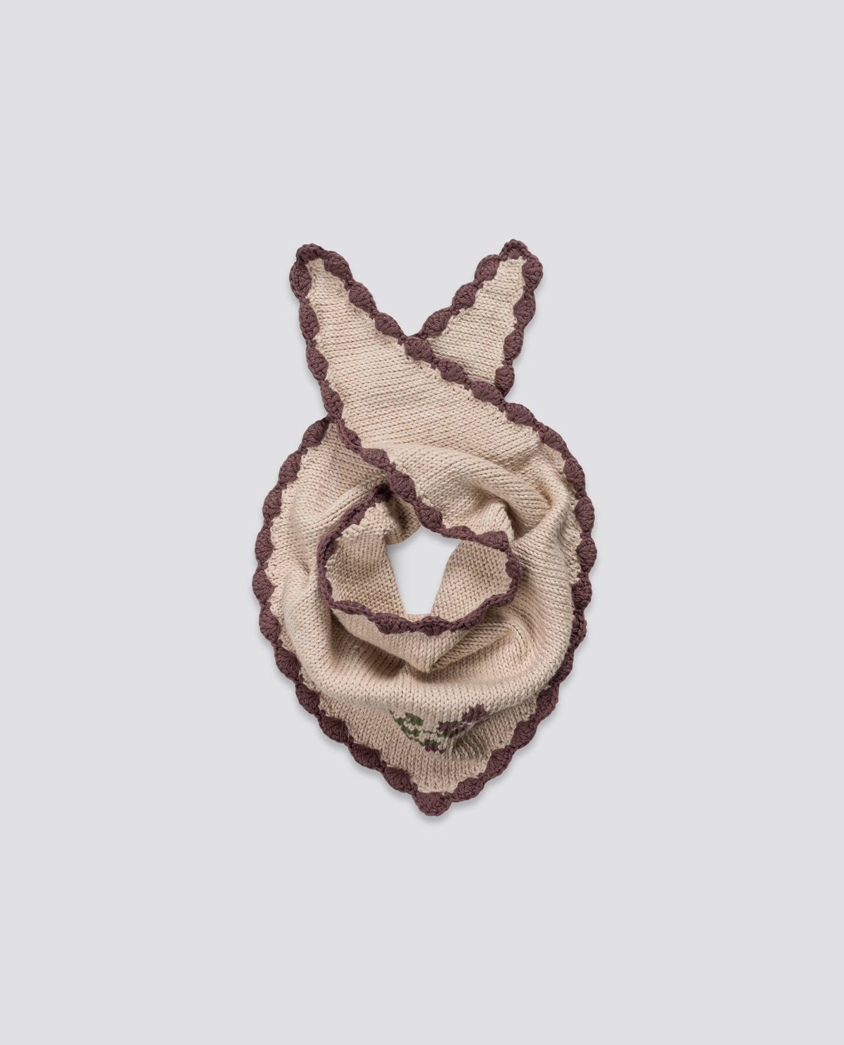 Soft cream and red cotton scarf with hand-knitted winter rose detail and vintage-inspired scalloped edges, crafting sustainably for children's organic clothing.