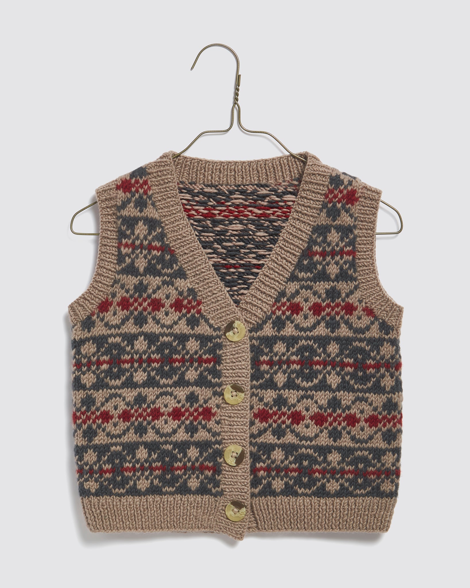Hand-knitted kids tank top vest in multicolor Fairisle pattern with beige, blue, and red stripes, made from sustainable Merino wool for vintage style children's clothing.