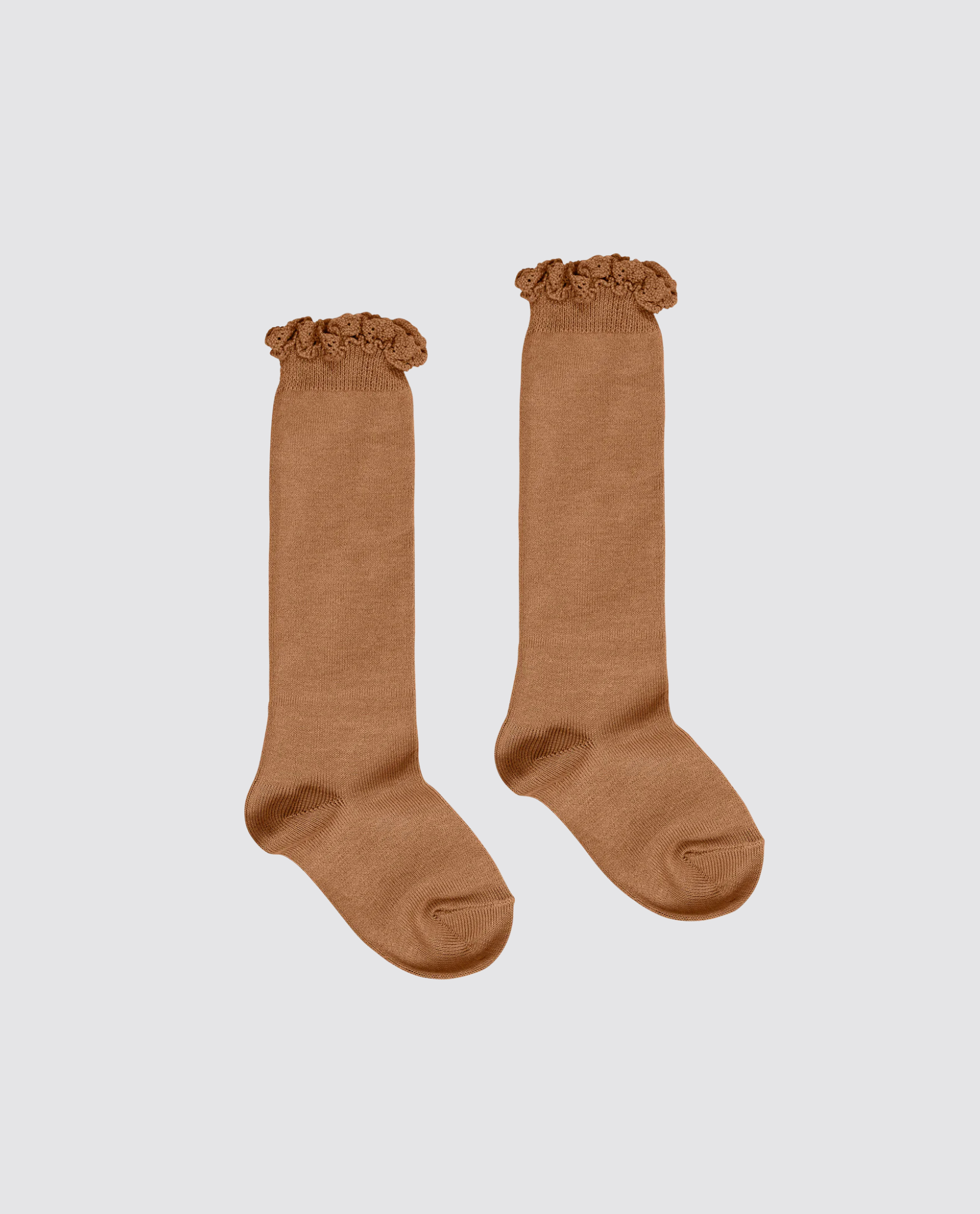 Pair of caramel brown knee-high socks for kids with delicate lace frill tops, made from soft cotton blend fabric, reflecting vintage style and sustainable, ethical craftsmanship.